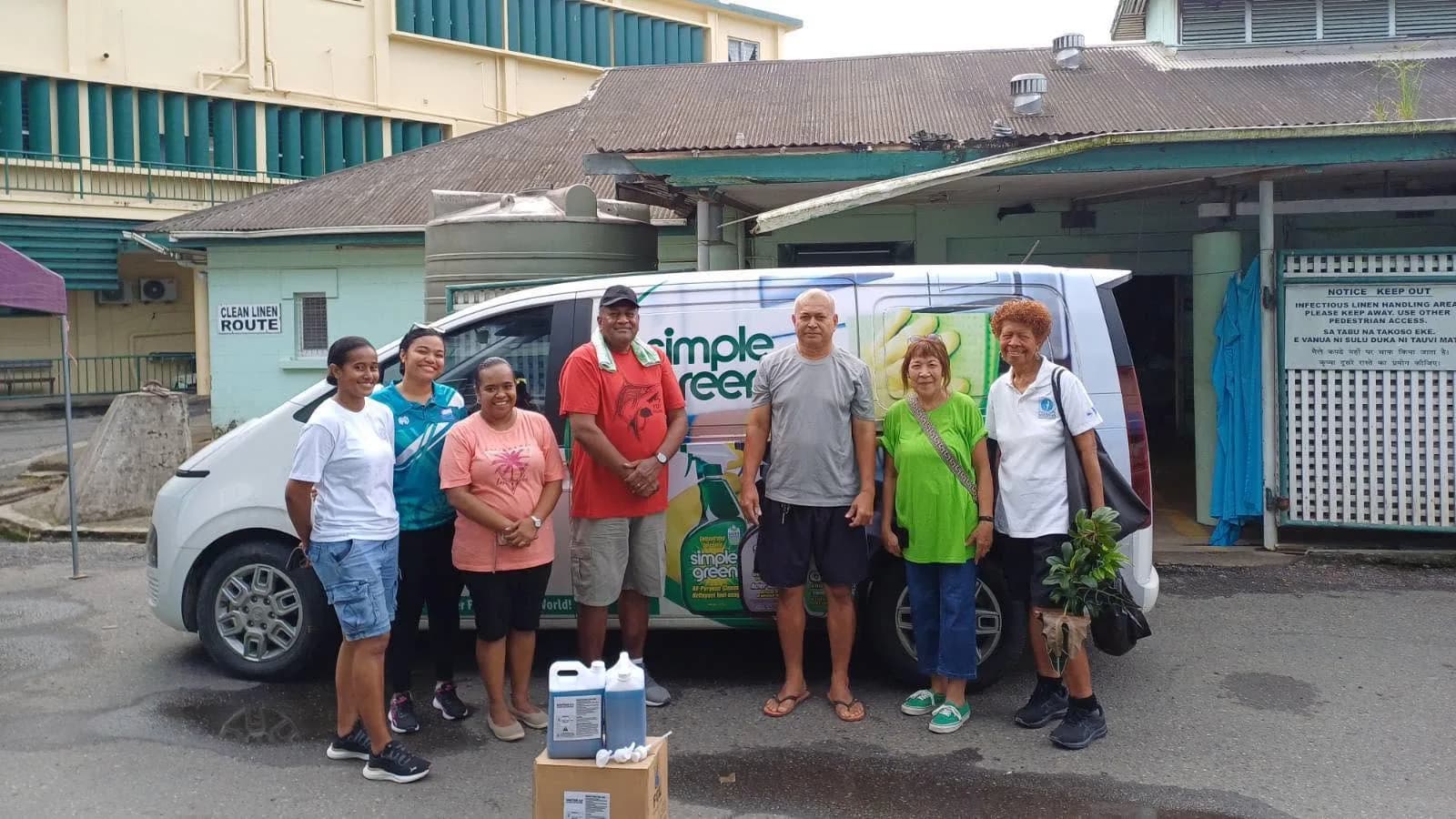 Volunteers and FCL representatives with cleaning products outside CWM