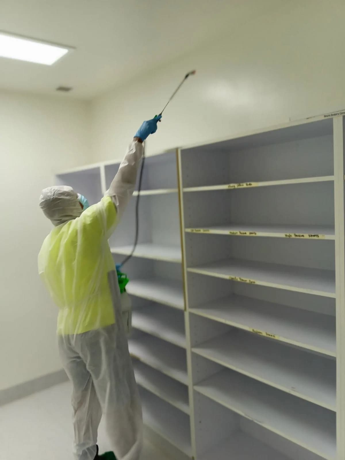 A cleaning team member working on high surfaces at CWM