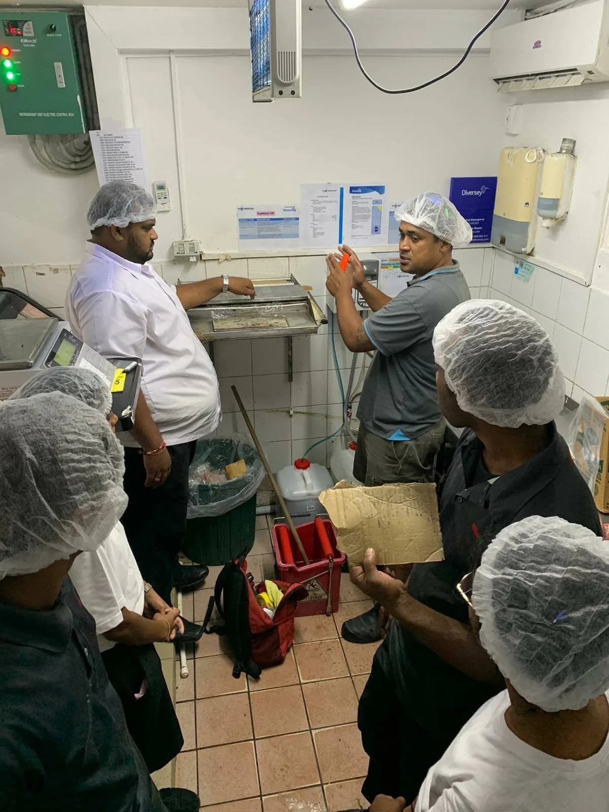 FCL trainer explaining product handling to New World Narere staff