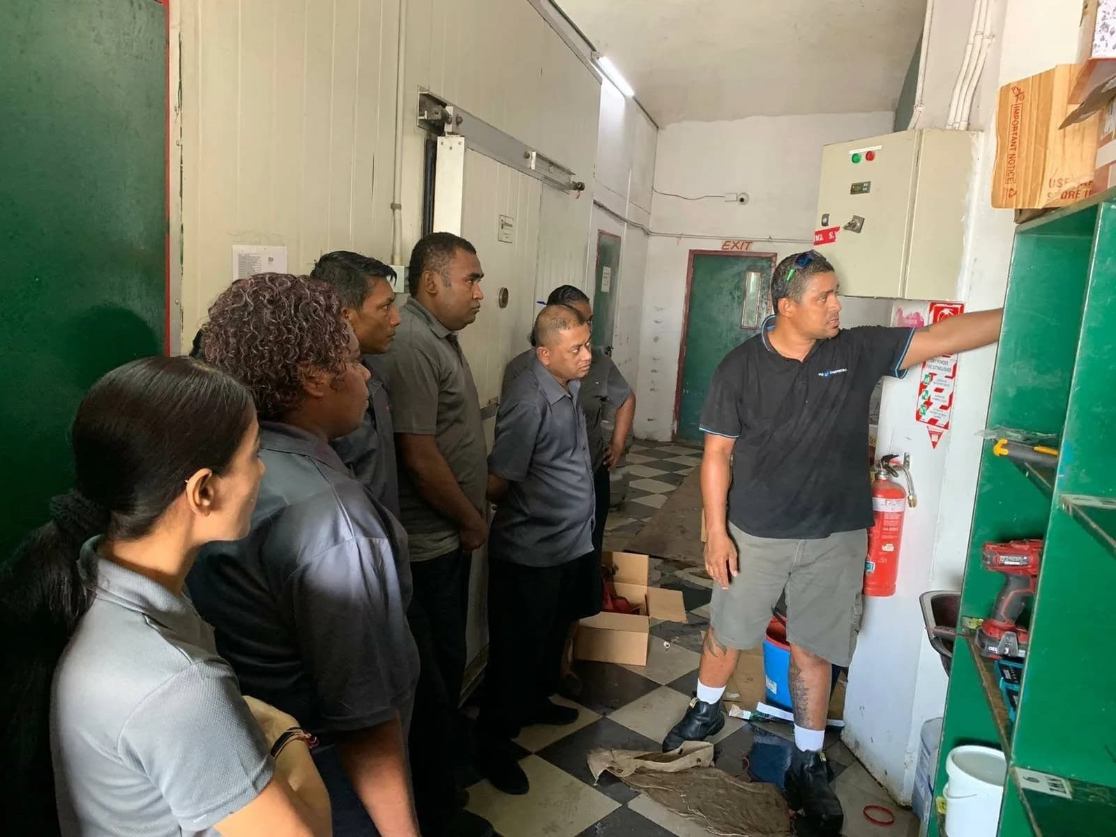 FCL trainer explaining a product information chart to New World staff