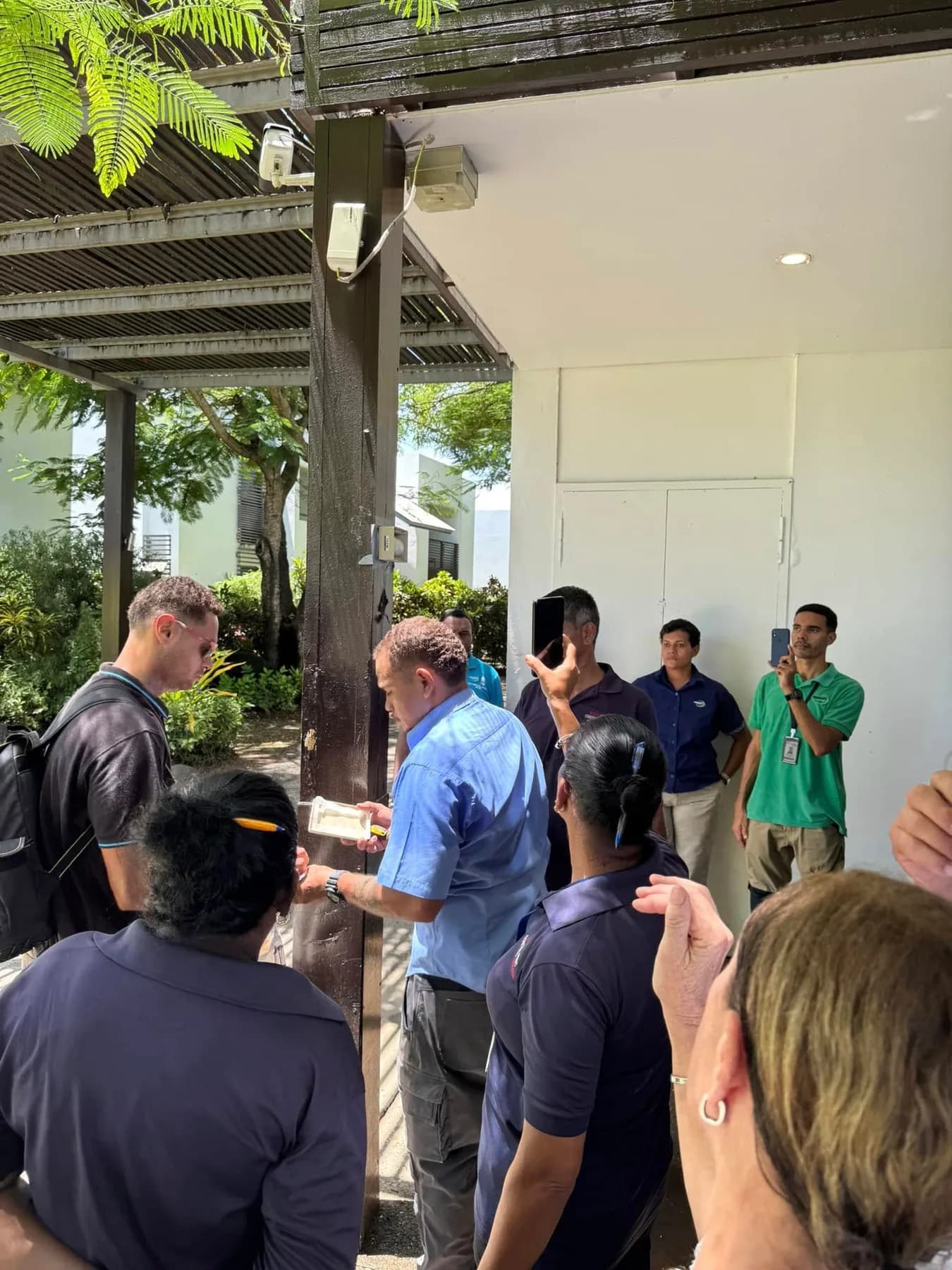 Participants gathered around an outdoor Sentricon bait-system demonstration