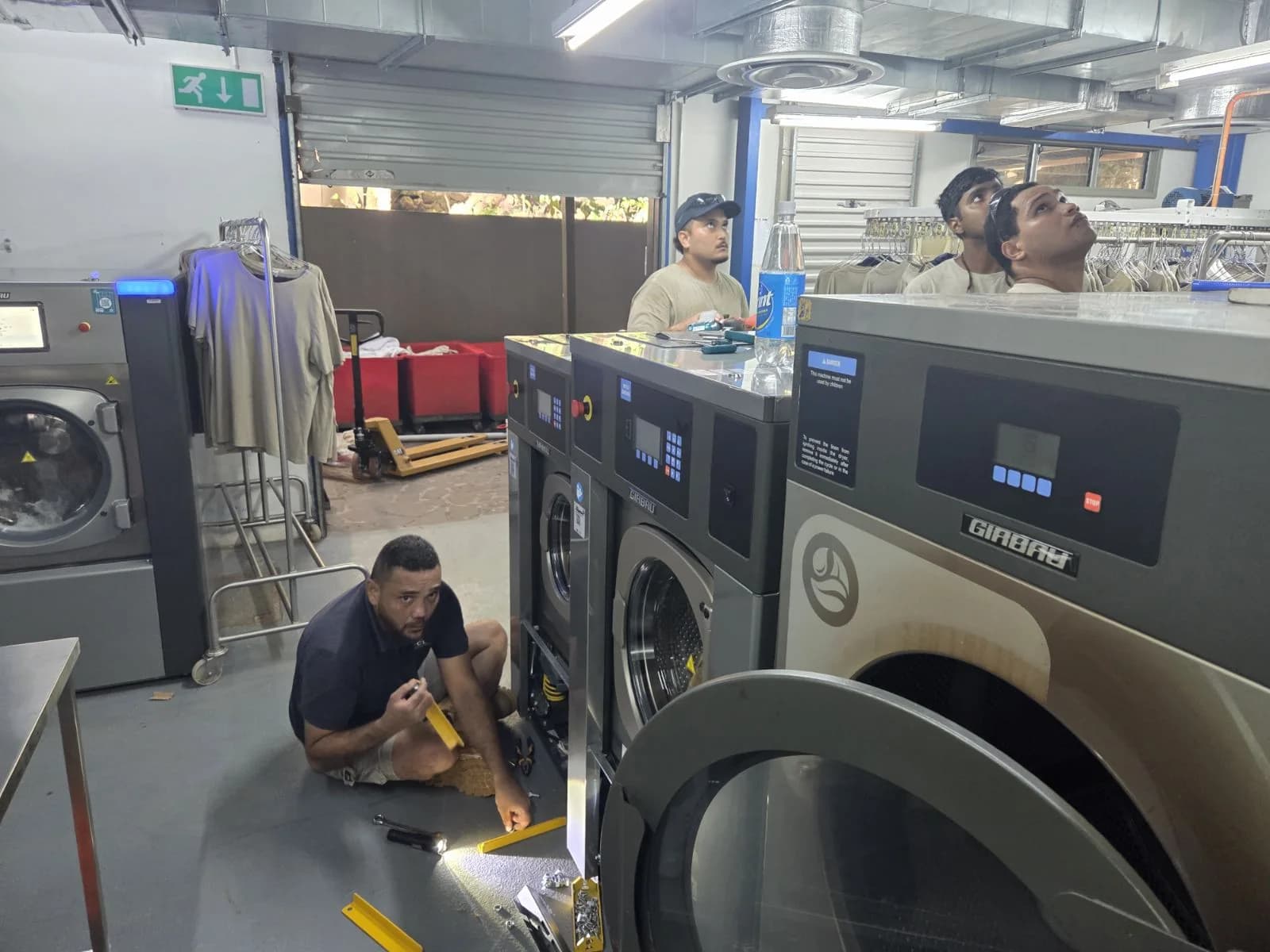 Fiji Chemicals team working on commercial laundry equipment