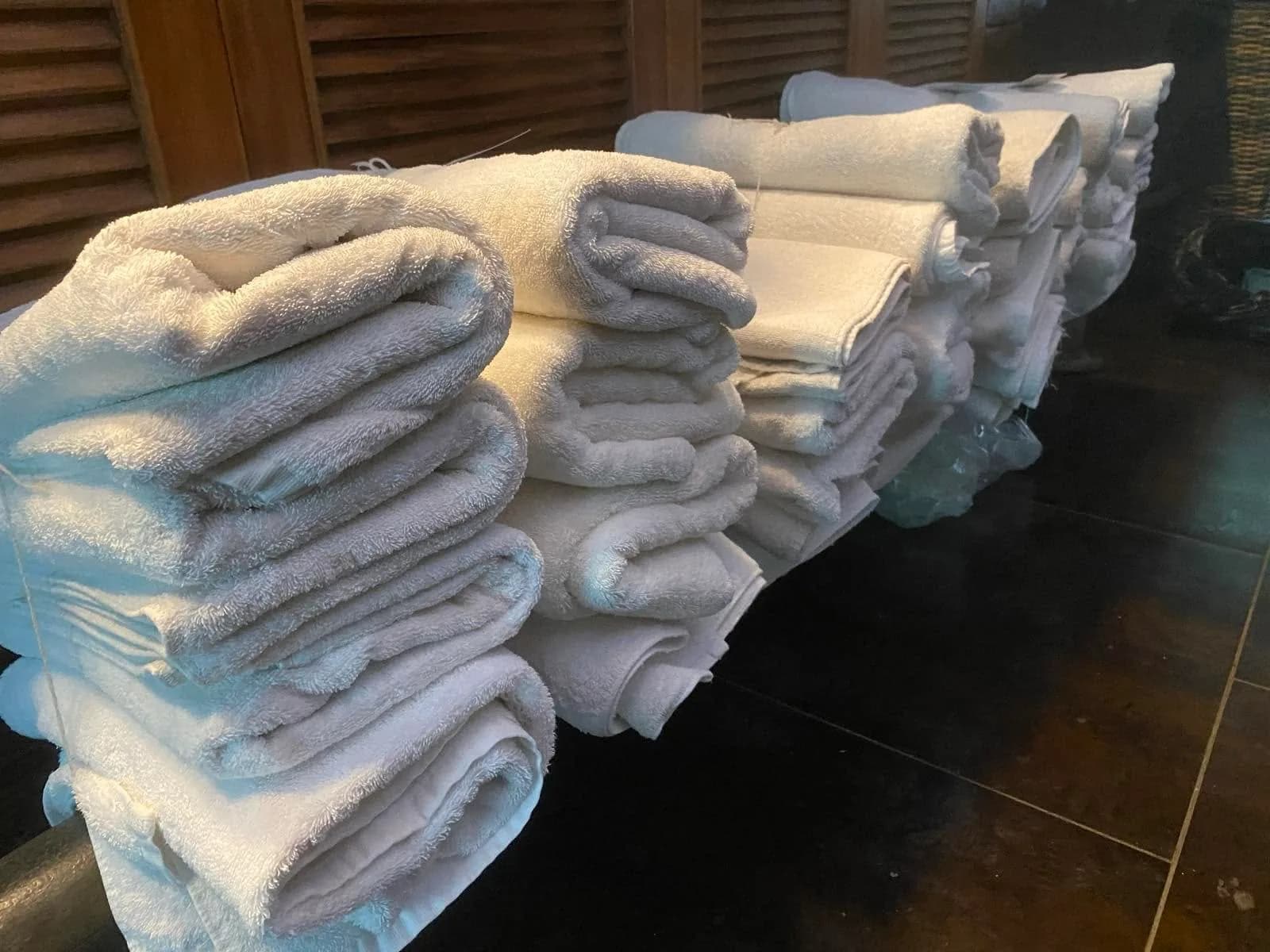 Folded towels and linen prepared for donation