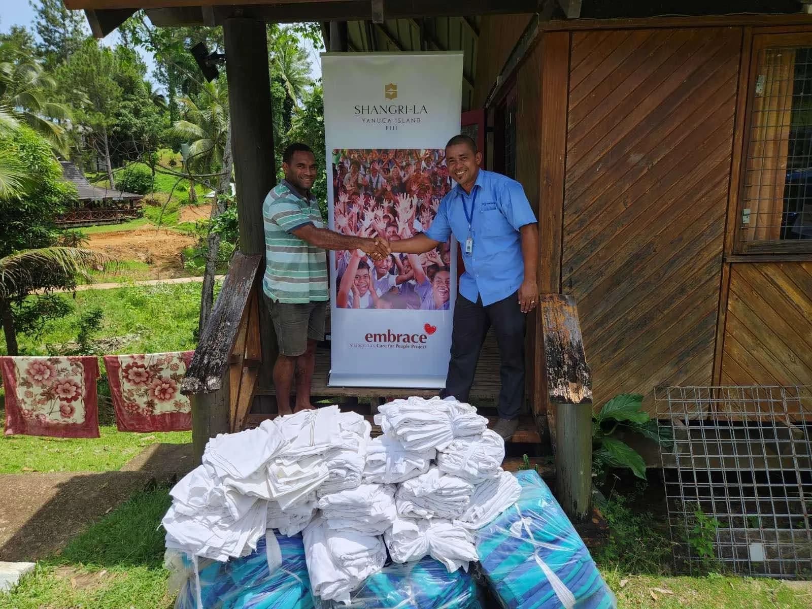 A handover of folded linen at the Centre for Appropriate Technology and Development