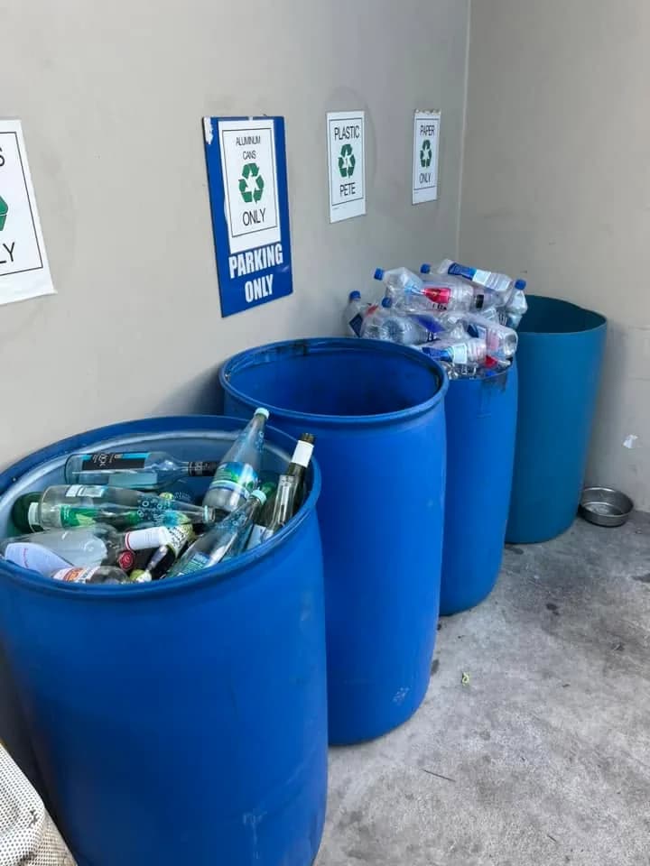 Glass bottles collected in a labelled recycling drum